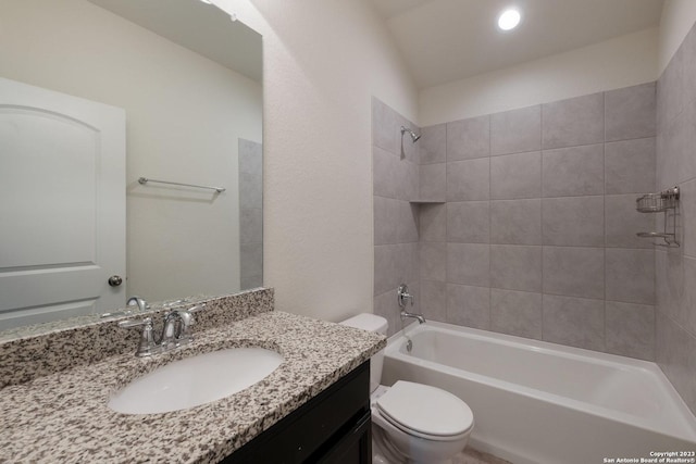 full bathroom featuring toilet, vanity, and tiled shower / bath combo