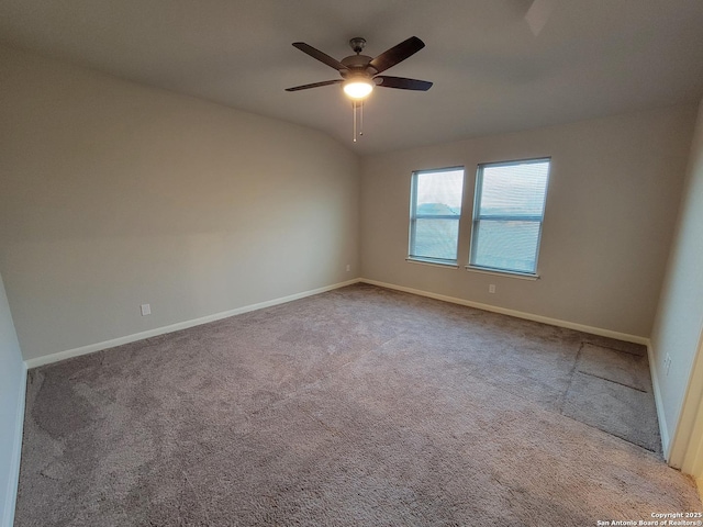 spare room featuring ceiling fan and carpet