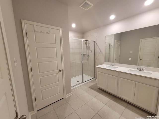 bathroom featuring vanity, a shower with door, and tile patterned floors