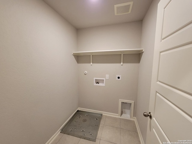 laundry area with washer hookup, light tile patterned floors, gas dryer hookup, and electric dryer hookup