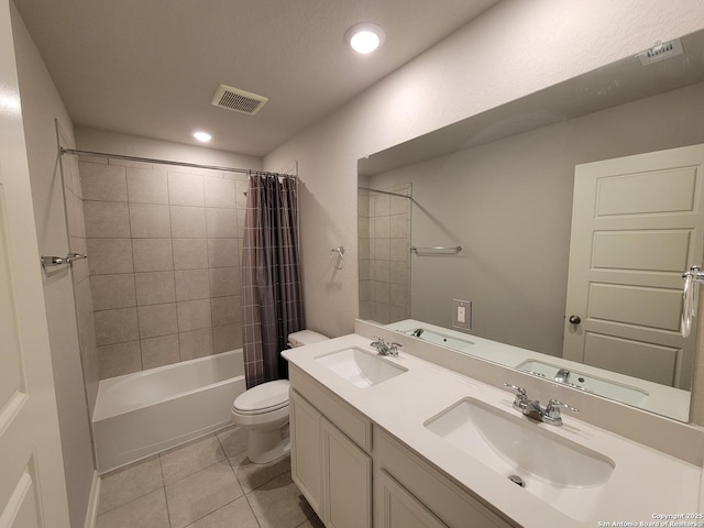 full bathroom featuring toilet, shower / bath combo, vanity, and tile patterned floors