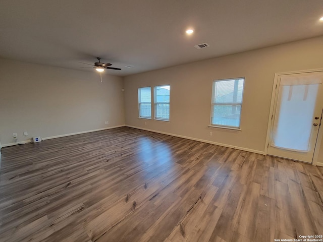 empty room with ceiling fan and hardwood / wood-style floors