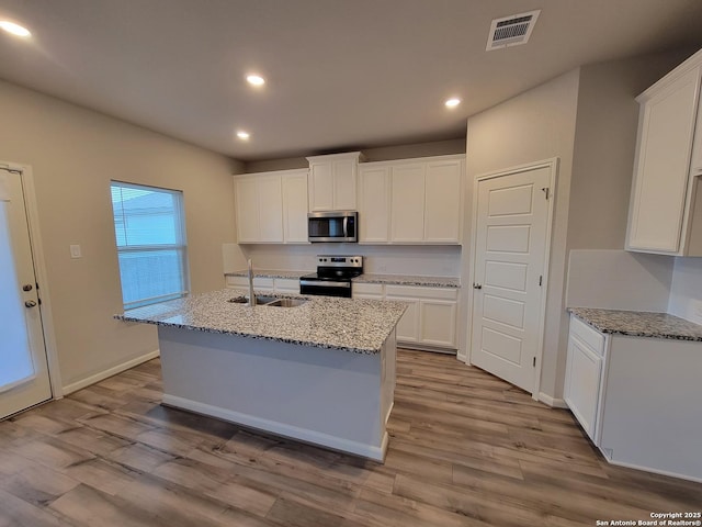 kitchen featuring white cabinets, appliances with stainless steel finishes, and sink