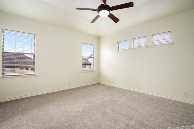 spare room with ceiling fan and carpet