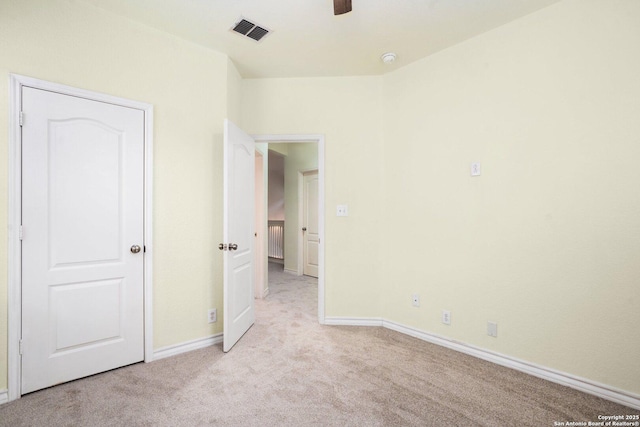 unfurnished bedroom featuring light colored carpet and ceiling fan