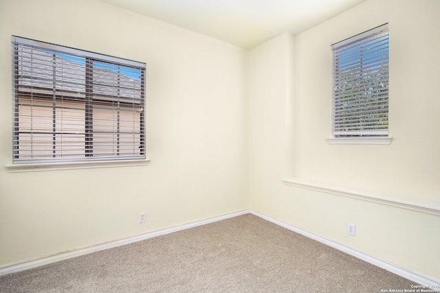 carpeted empty room with plenty of natural light