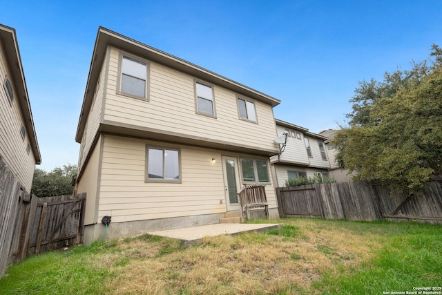 back of house featuring a yard