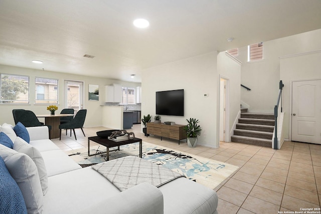 living room with light tile patterned floors and sink