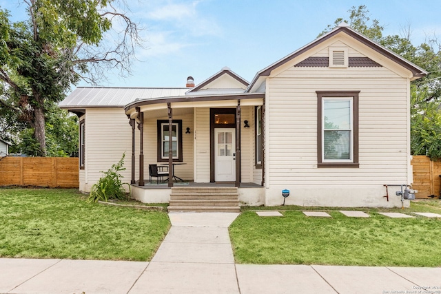 view of front of property with a front yard and covered porch