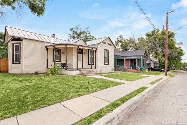 view of front of home featuring covered porch and a front lawn