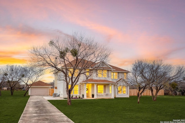 view of front of home with a porch, central AC, and a yard