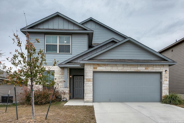 craftsman-style house featuring a garage and cooling unit