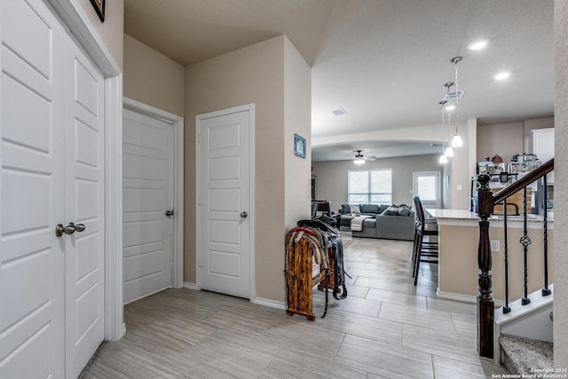 hallway with a textured ceiling