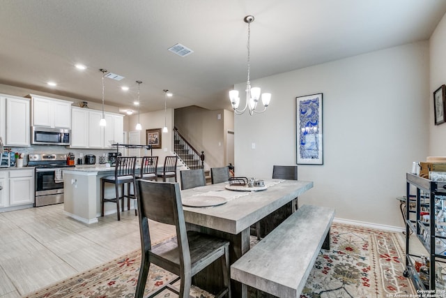 dining area featuring a notable chandelier