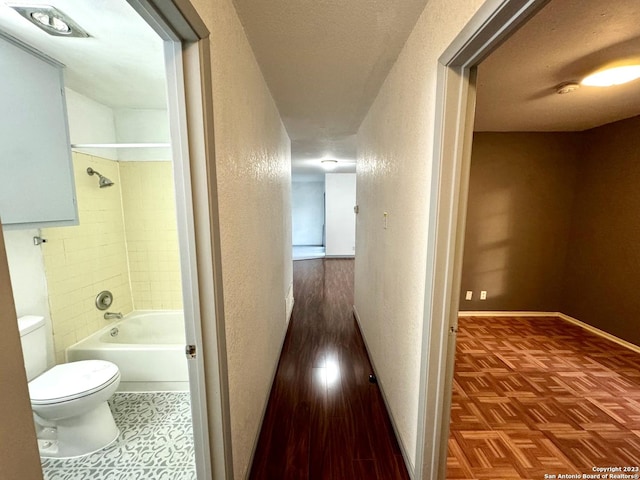 hallway with a textured ceiling