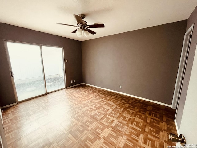 spare room with ceiling fan and parquet flooring