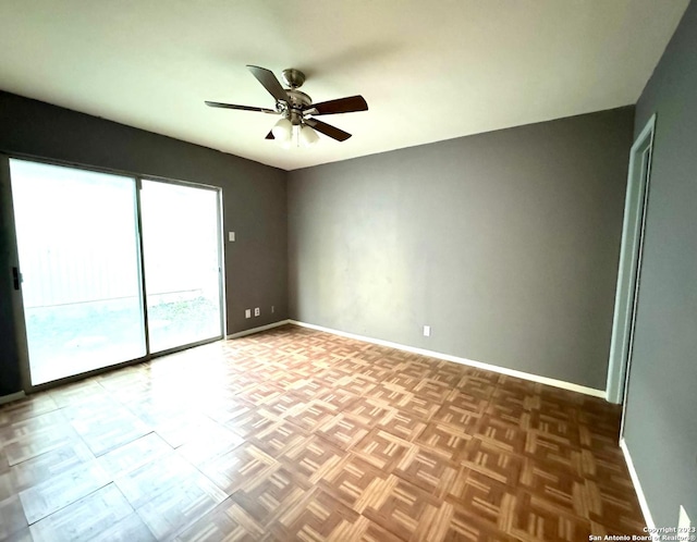 unfurnished room with ceiling fan and parquet floors