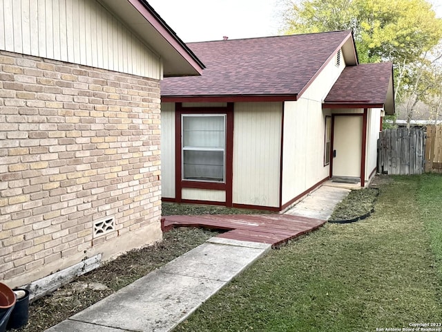 view of exterior entry with a lawn