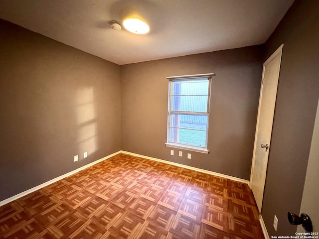 unfurnished room with parquet floors