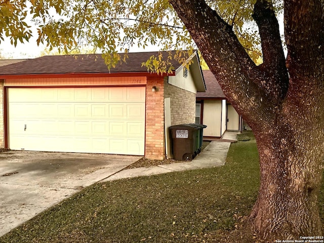 exterior space with a garage and a front yard