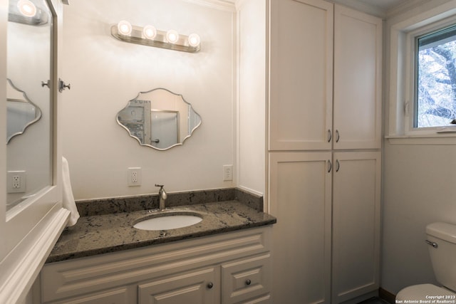 bathroom featuring toilet and vanity