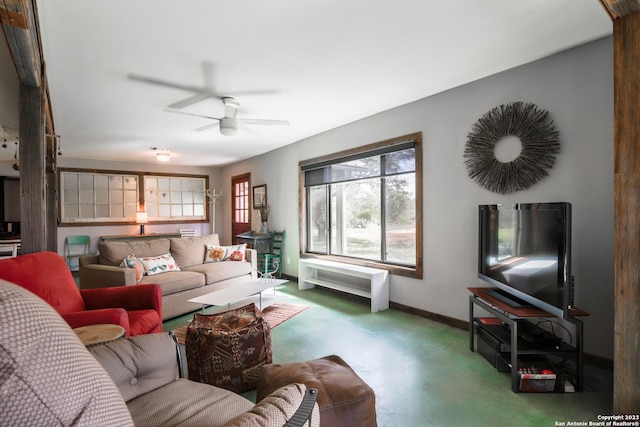 living room with ceiling fan and concrete floors