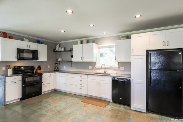 kitchen with black appliances, white cabinets, and sink