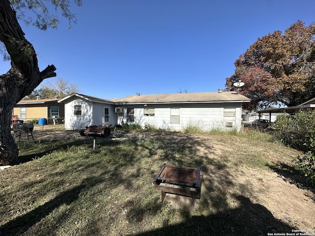 back of property featuring a yard