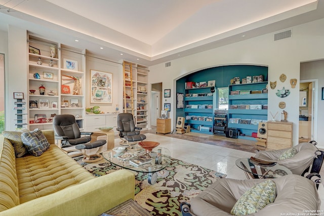 tiled living room featuring lofted ceiling and built in features