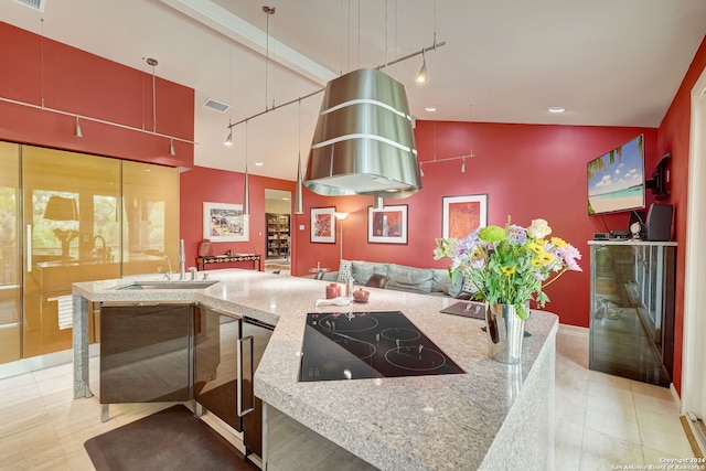 kitchen featuring light stone countertops, sink, black electric cooktop, and rail lighting