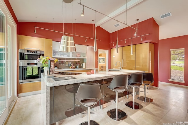 kitchen with stainless steel double oven, decorative light fixtures, a kitchen bar, beamed ceiling, and high vaulted ceiling