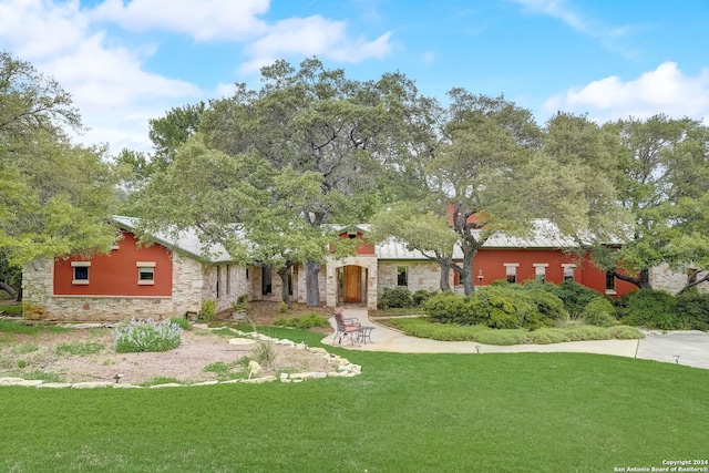 view of front of home with a front lawn and a patio area