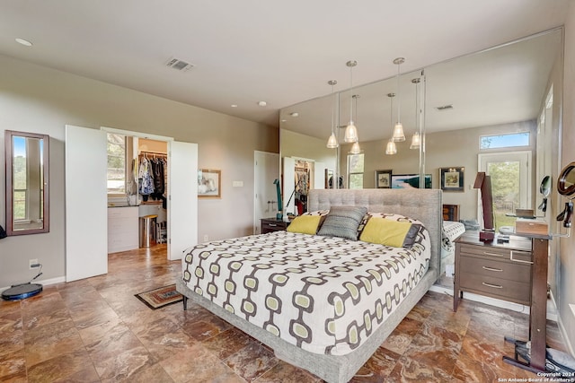 bedroom featuring a spacious closet and a closet