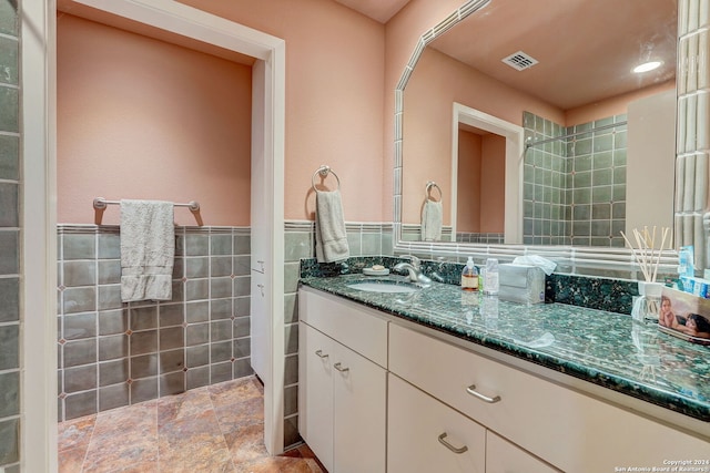 bathroom featuring tile walls and vanity