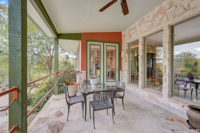 sunroom / solarium featuring lofted ceiling and ceiling fan