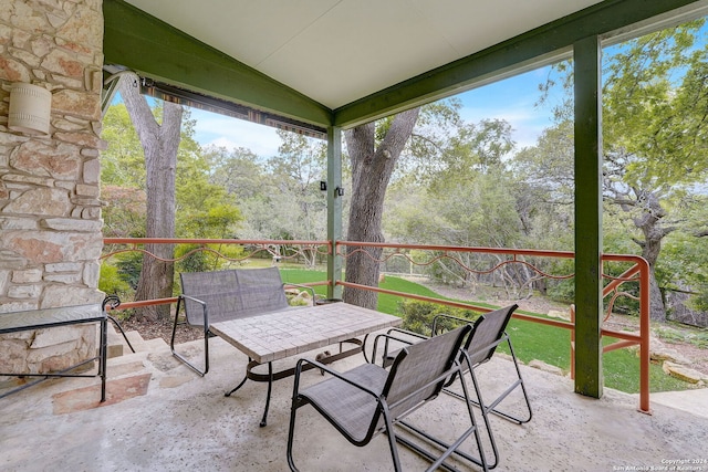 unfurnished sunroom featuring plenty of natural light and vaulted ceiling