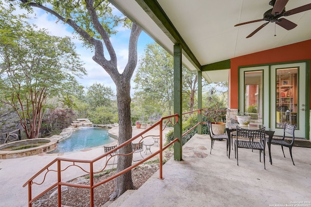 exterior space featuring a pool with hot tub and ceiling fan