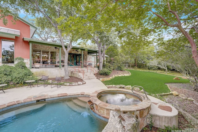 view of pool featuring a patio area, a yard, and an in ground hot tub