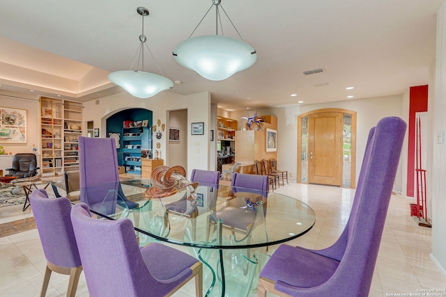 dining room with light tile patterned floors and built in features