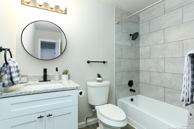 full bathroom with toilet, tiled shower / bath combo, and vanity