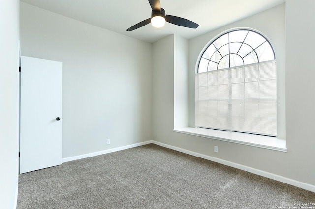 carpeted empty room featuring ceiling fan