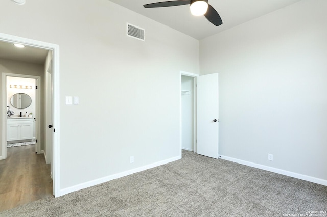 empty room with ceiling fan and carpet