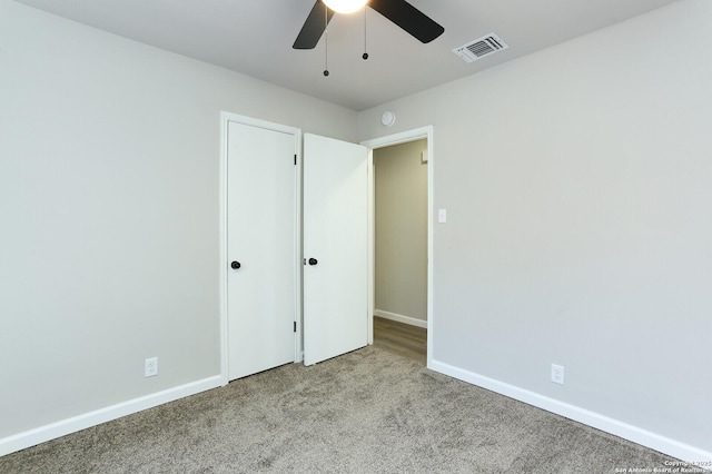 unfurnished bedroom featuring ceiling fan and light carpet