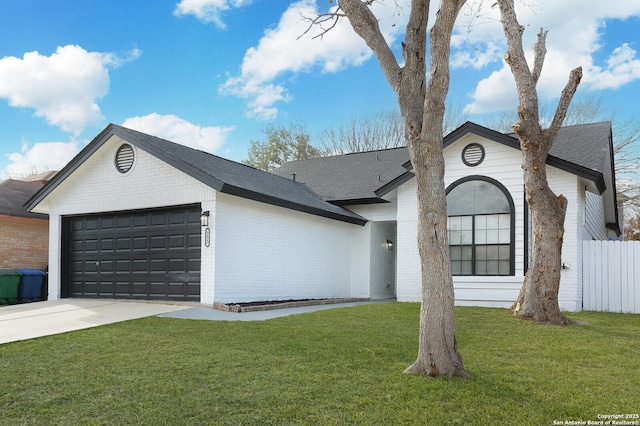 ranch-style house featuring a garage and a front lawn