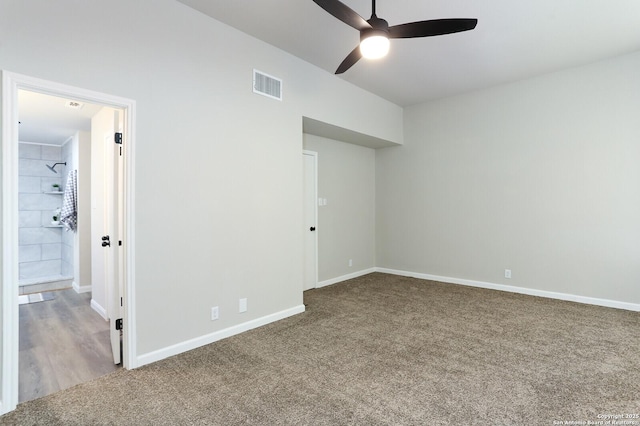 unfurnished bedroom featuring ensuite bath, ceiling fan, and carpet