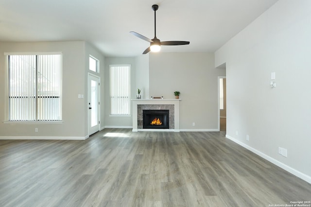 unfurnished living room with ceiling fan and light wood-type flooring