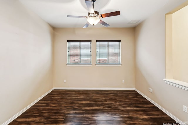 empty room featuring ceiling fan and dark hardwood / wood-style floors