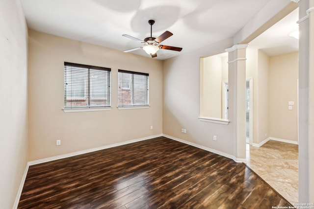 unfurnished room featuring ceiling fan, dark hardwood / wood-style floors, and decorative columns