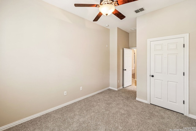 unfurnished bedroom featuring ceiling fan and light carpet