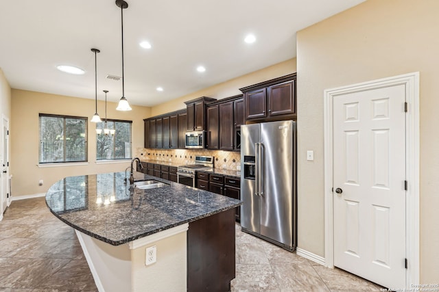 kitchen featuring decorative light fixtures, backsplash, sink, premium appliances, and dark brown cabinets